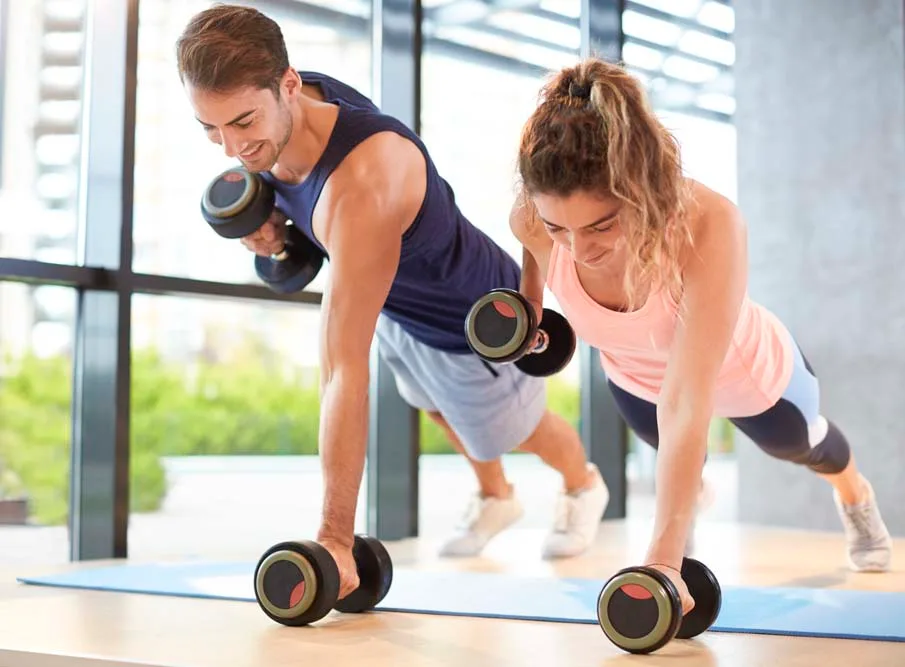 Couple working out with hand weights. They need some Hempexco CBD products for muscle recovery
